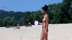 Bombastic young nudist babes sunbathe nude at the beach